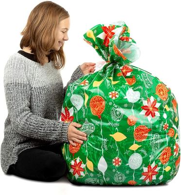 Ζωηρόχρωμες πλαστικές τσάντες περικαλυμμάτων δώρων σχεδίου συνήθειας για την τεράστια παρούσα συσκευασία Χριστουγέννων